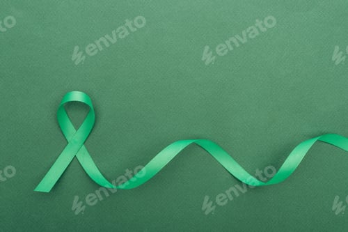 Preview: top view of green and colorful ribbon on green background with copy space