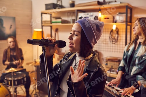 Preview: Young pretty female musician recording songs