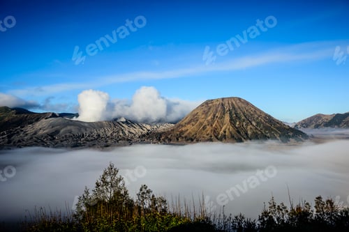 Preview: High angle view of clouds under smoking volcano