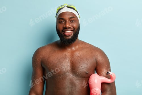 Preview: People and recreation concept. Pleased dark skinned man with wet skin, has fun while swimming in poo