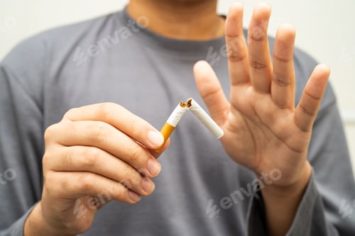 Preview: Quit smoking, Asian teenage man breaking destroy cigarette in hand.