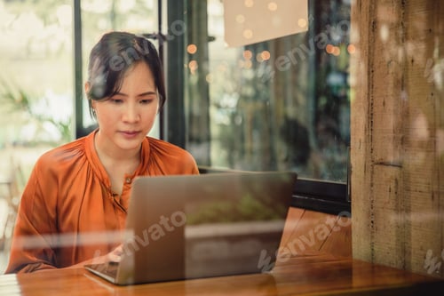 Preview: A woman working on laptop in the cafe.