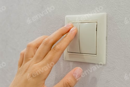 Preview: save energy - switch off. Close up of finger is turning on or off on light switch. Copy space.