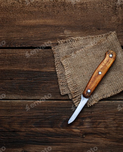 Preview: Knife and sucking napkin on wooden background