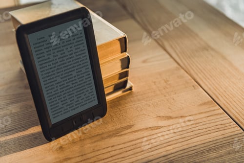 Preview: black ebook near paper books on wooden table