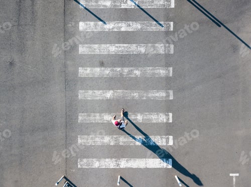Preview: top aerial view of on man walking on the crosswalk in street, abstract isolated disign with copy spa