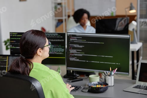 Preview: Young IT Technician Writing Code on PC