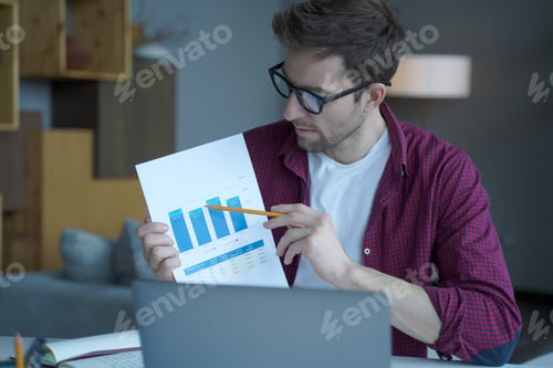 Preview: Young austrian guy freelancer analyzing project results or financial report with team online,