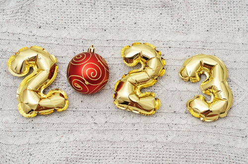 Preview: inscription 2023 consists of golden inflatable numbers and a Christmas tree toy - a red ball on a