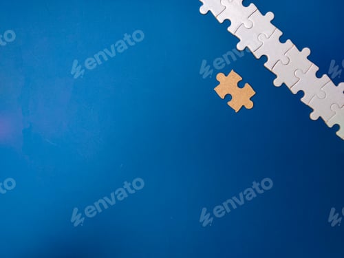 Preview: Unfinished white jigsaw puzzle pieces on blue background