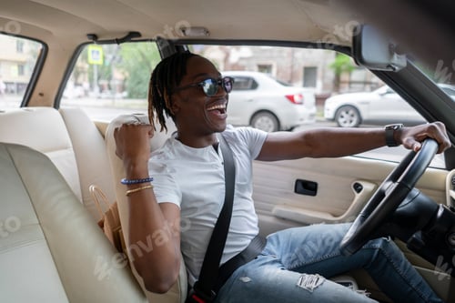 Preview: a young happy male driver riding a car, cheerful person
