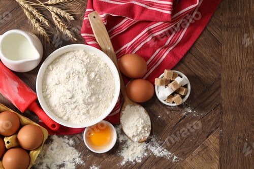 Preview: Rolling pin and ingredients for dough on wooden table, flat lay. Space for text
