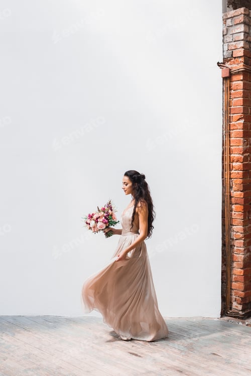 Preview: Beautiful Woman in Dress Holding Flowers