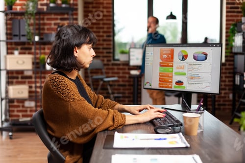 Preview: Entrepreneur looking at computer screen analyzing digital marketing graphs