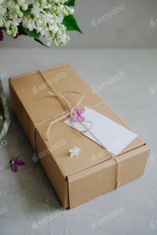 Preview: Gift craft box with a bow made of twine. The package.