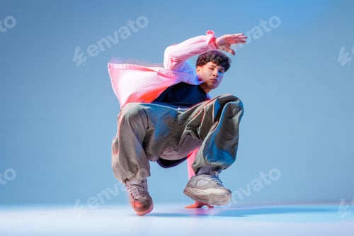Preview: Bboy breakdance freeze low angle with neon studio lighting and copy space