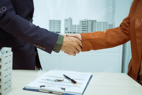 Preview: A businessman shakes hands with customer in the sales office after agreeing sign contract to buy
