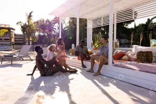 Preview: Happy diverse friends having party by swimming pool, drinking beer