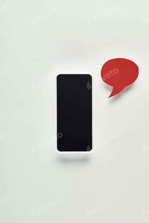 Preview: top view of smartphone with blank screen on white background near red empty speech bubble,