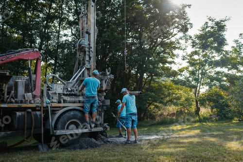 Preview: Water well drilling rig preparing to boring dowin into the earth.