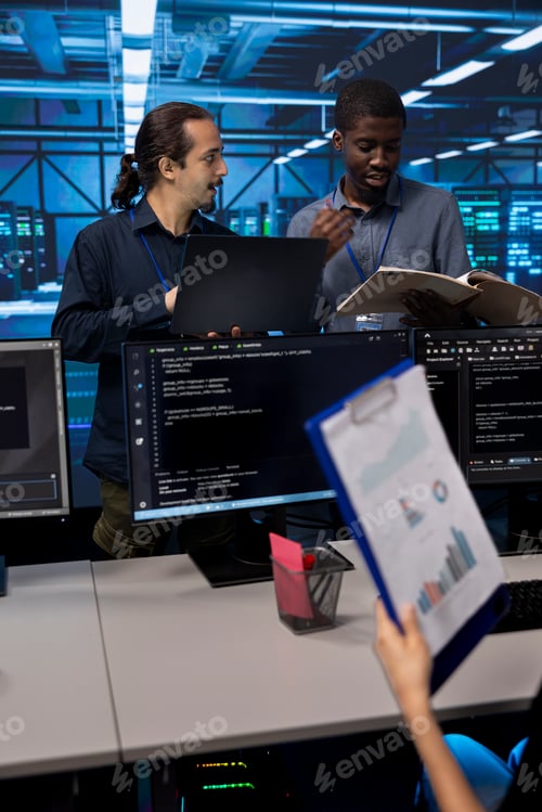Preview: Man inspects server hub infrastructure, reading paperwork