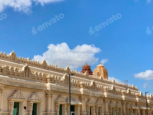 Preview: Beautiful view of a temple with intricate carvings under a clear blue sky