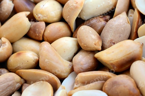 Preview: Peanut. A lot of small yellow nuts without peel. Background texture