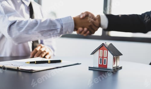 Preview: Real estate agents businessmen shake hands after the signing of the contract agreement is complete.