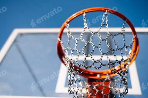 Preview: Basketball hoop chain net hanging on outdoor court under blue sky