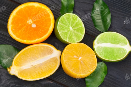 Preview: Citrus fruits slice on a black wooden background