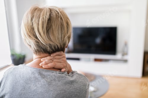 Preview: Senior woman in living room with neck pain