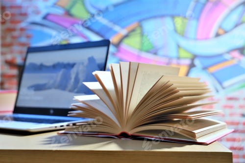 Preview: close-up of a fanned book with computer