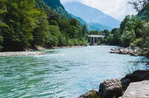 Preview: Bungee jumping and metal bridge on a mountain blue rocky river on a summer day