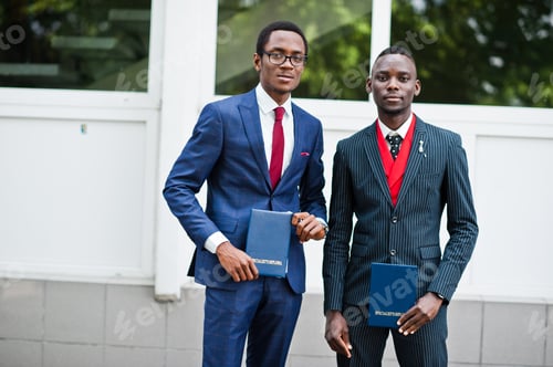 Preview: Two african american happy successful mans at suit with diploma at graduation day.