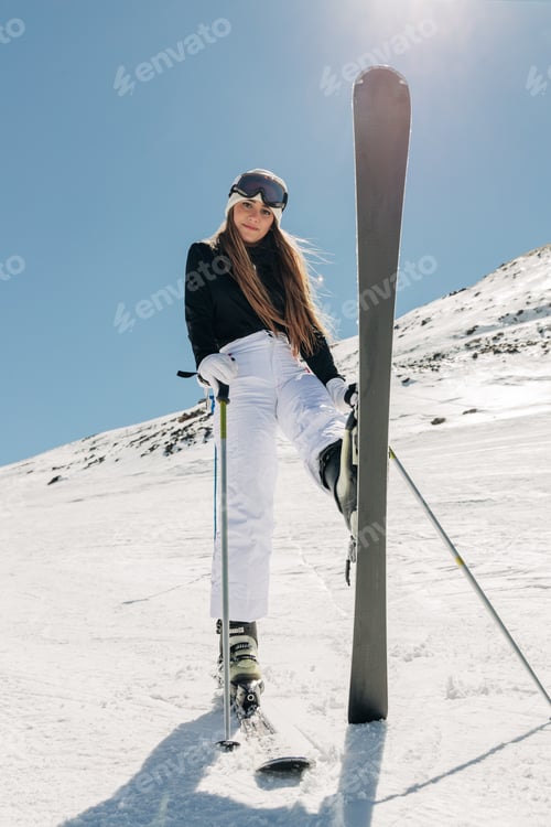 Preview: Female skier standing on snowy slope