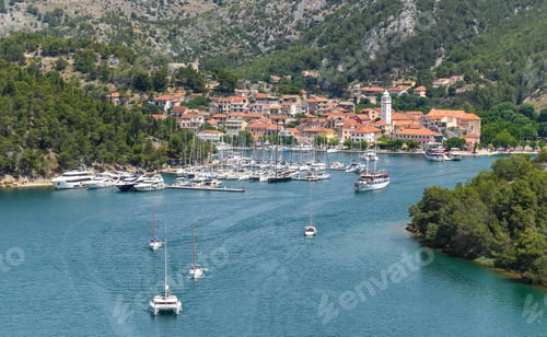Preview: Landscape of ships and boats on a river surrounded by the Old Town of Skradin, Croatia