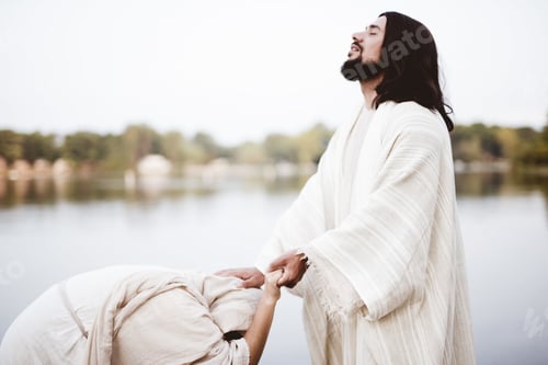 Preview: Shallow focus shot of Jesus Christ healing a female with his hand on her head
