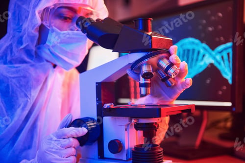 Preview: Nurse in mask and white uniform sitting in neon lighted laboratory