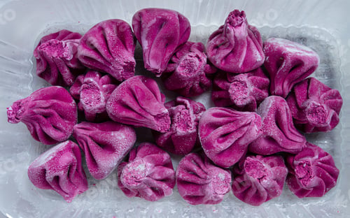 Preview: freshly frozen beetroot khinkali, in a container, top view, no people,