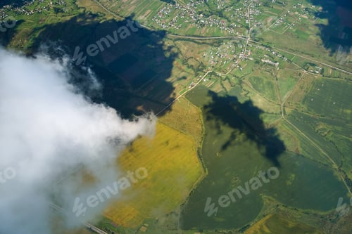 Preview: Aerial view from high altitude of earth covered with white puffy cumulus clouds on sunny day