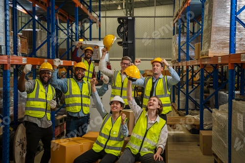 Preview: Successful warehouse team smiling happily,Cheerful logistics workers in a large warehouse.