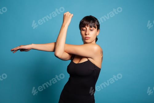 Preview: Portrait of fit active woman stretching arm muscles training body endurance
