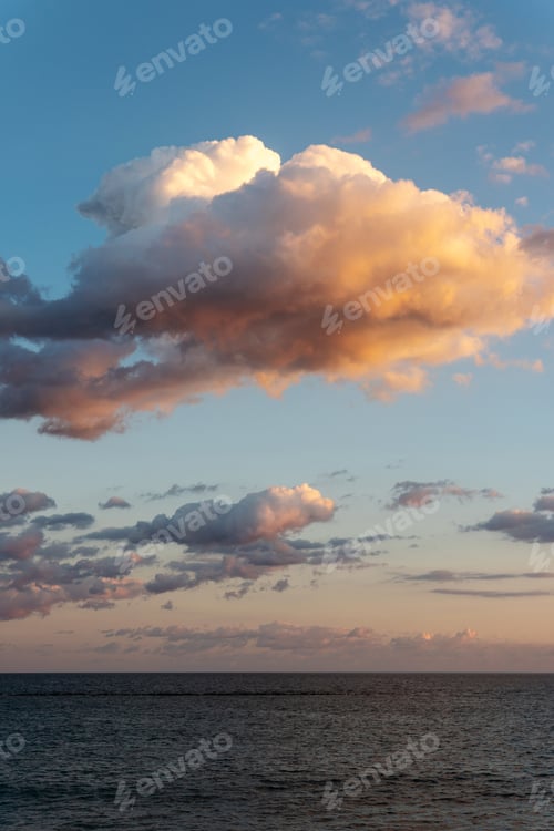 Preview: Golden Clouds Over Calm Ocean at Sunset