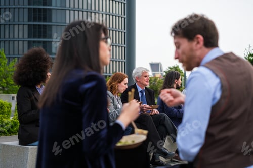 Preview: Group of business district workers taking a break - focus on white-haired man