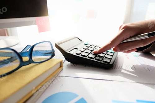 Preview: Close up Accountant using calculator for calculating financial expense at home office