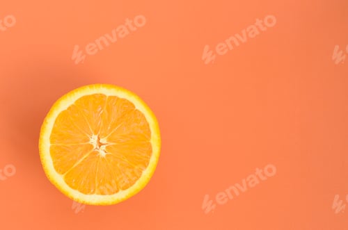 Preview: Top view of a one orange fruit slice on bright background in orange color