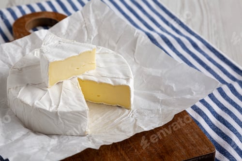 Preview: Homemade White Brie Cheese on a Wooden Board, side view.