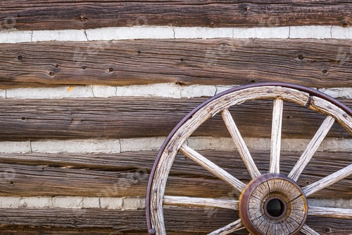 Preview: Abstract of Vintage Antique Log Cabin Wall and Wagon Wheel.