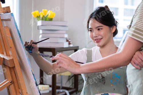 Preview: Young Women Enjoying Creative Time Together Drawing Pictures in a Bright Modern Studio