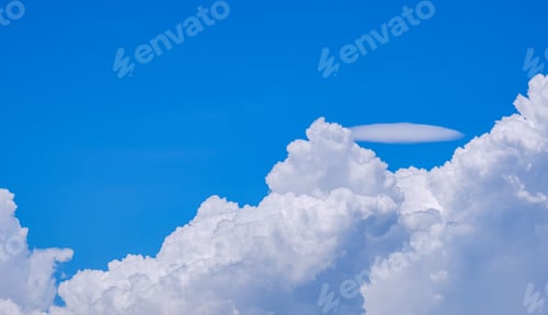 Preview: White Cumulus congestus and Pileus clouds on blue sky background in sunny day